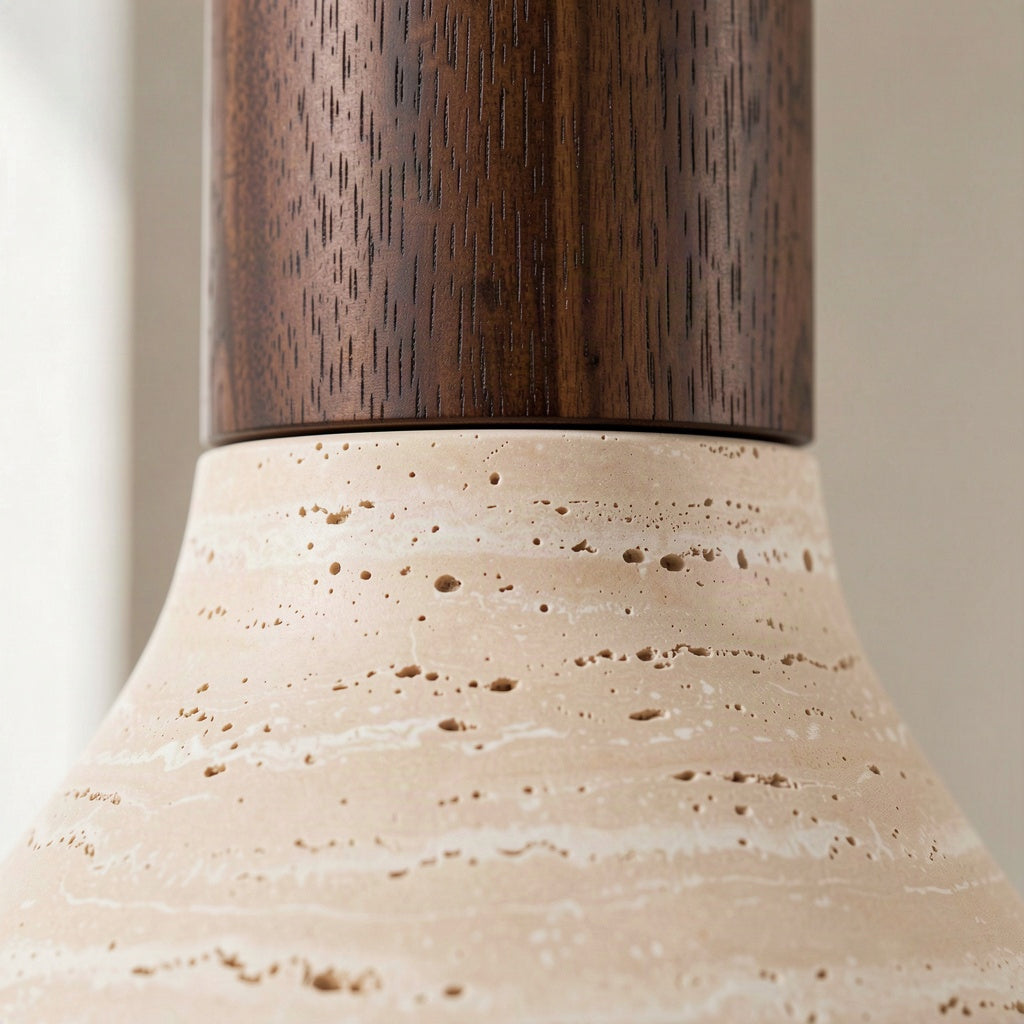 Close-up of the join between the walnut stem and the open-pored travertine shade