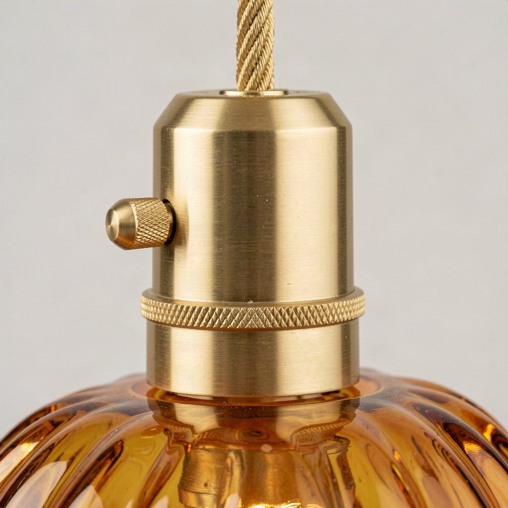 Close-up of the brass lampholder with knurled collar and side switch above the amber glass