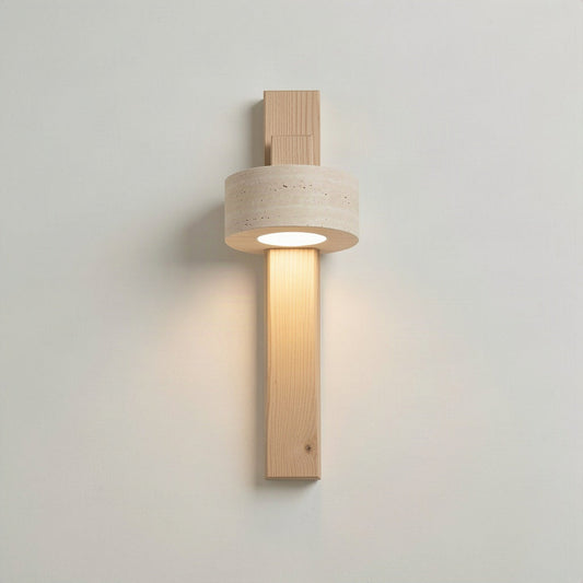 Travertine stone wall light with natural wood body, lit, mounted on a plain wall