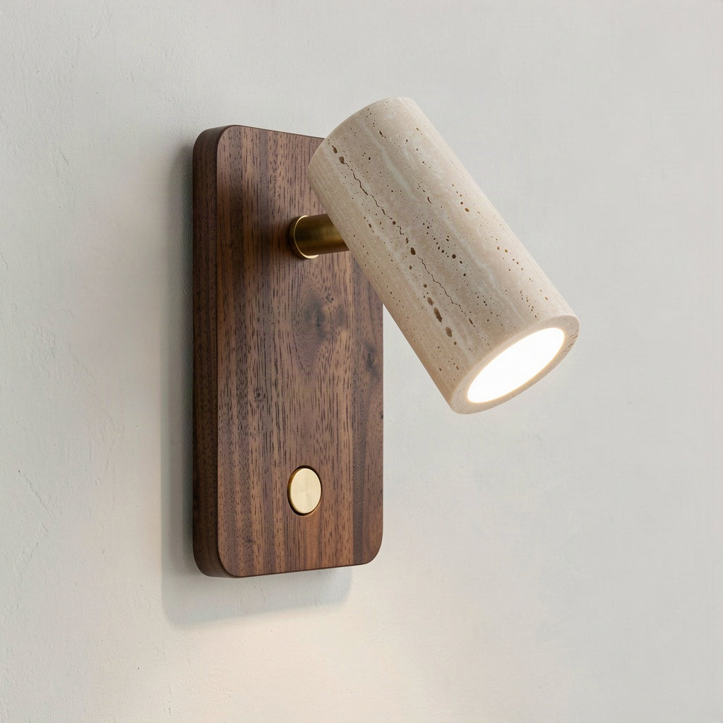 Angled view showing the travertine head on its brass pivot and the brass button switch