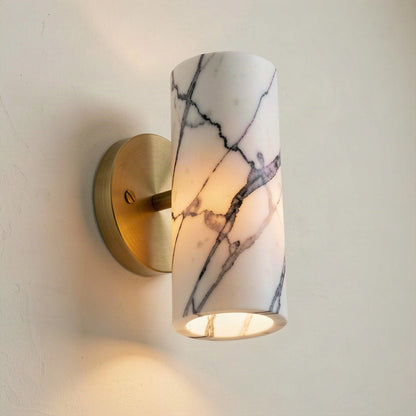 Angled view showing the open top and bottom of the marble cylinder and the brass stem