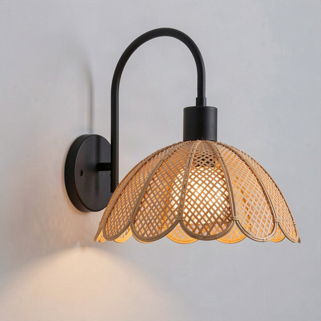 Angled view showing the swan-neck arm and the shallow dome of the rattan shade