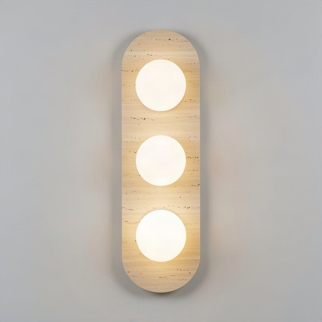 Travertine stone wall light with three opal glass globes set into the stone face