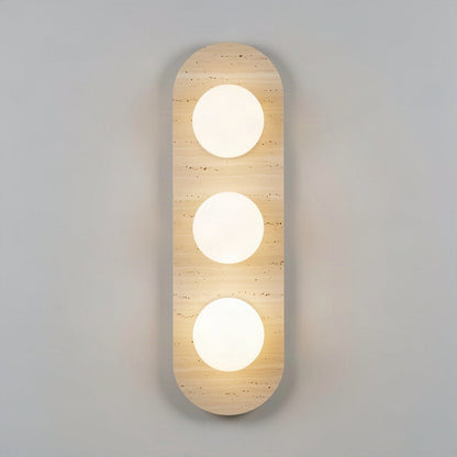 Travertine stone wall light with three opal glass globes set into the stone face