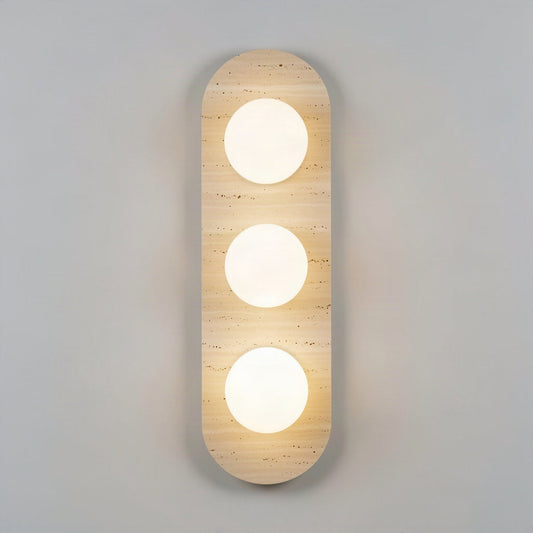 Travertine stone wall light with three opal glass globes set into the stone face