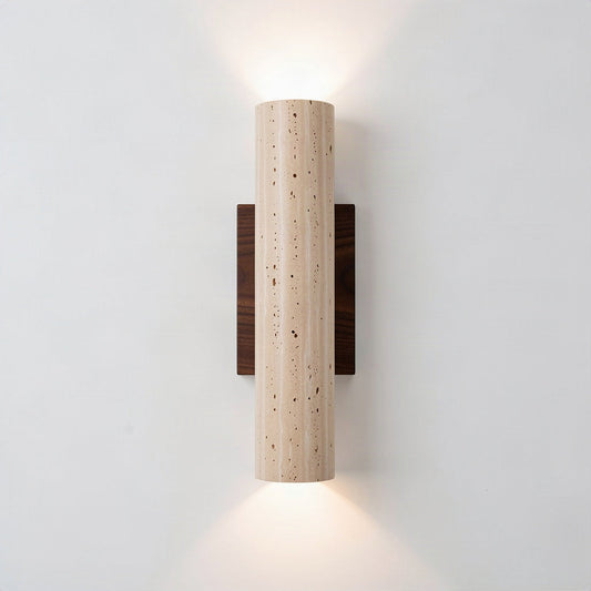 Travertine column wall light on a walnut backplate, throwing light up and down a pale wall