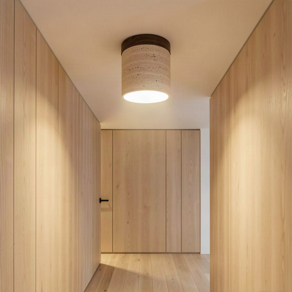 The travertine ceiling light lit in a timber-panelled hallway, casting light down the corridor