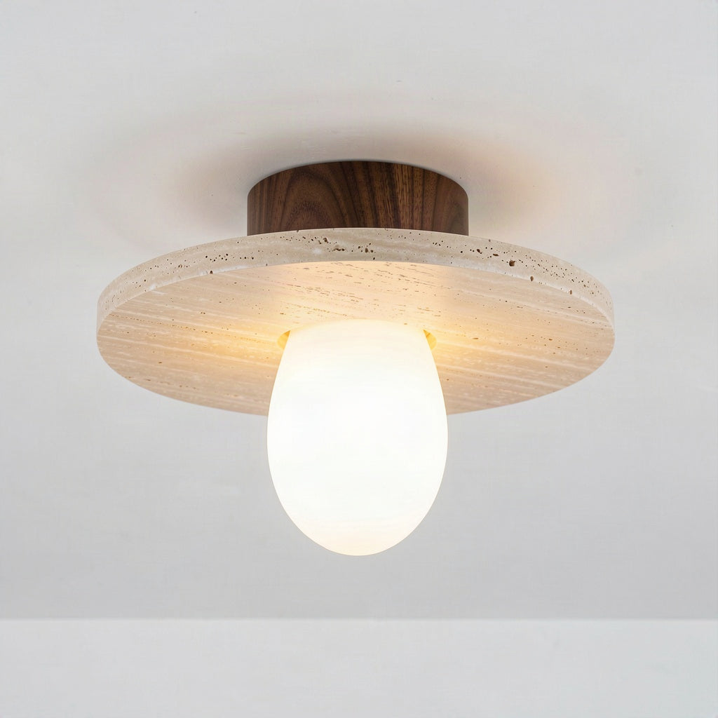 Travertine disc ceiling light with walnut canopy and opal diffuser on a plain ceiling