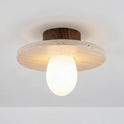 Travertine disc ceiling light with walnut canopy and opal diffuser on a plain ceiling