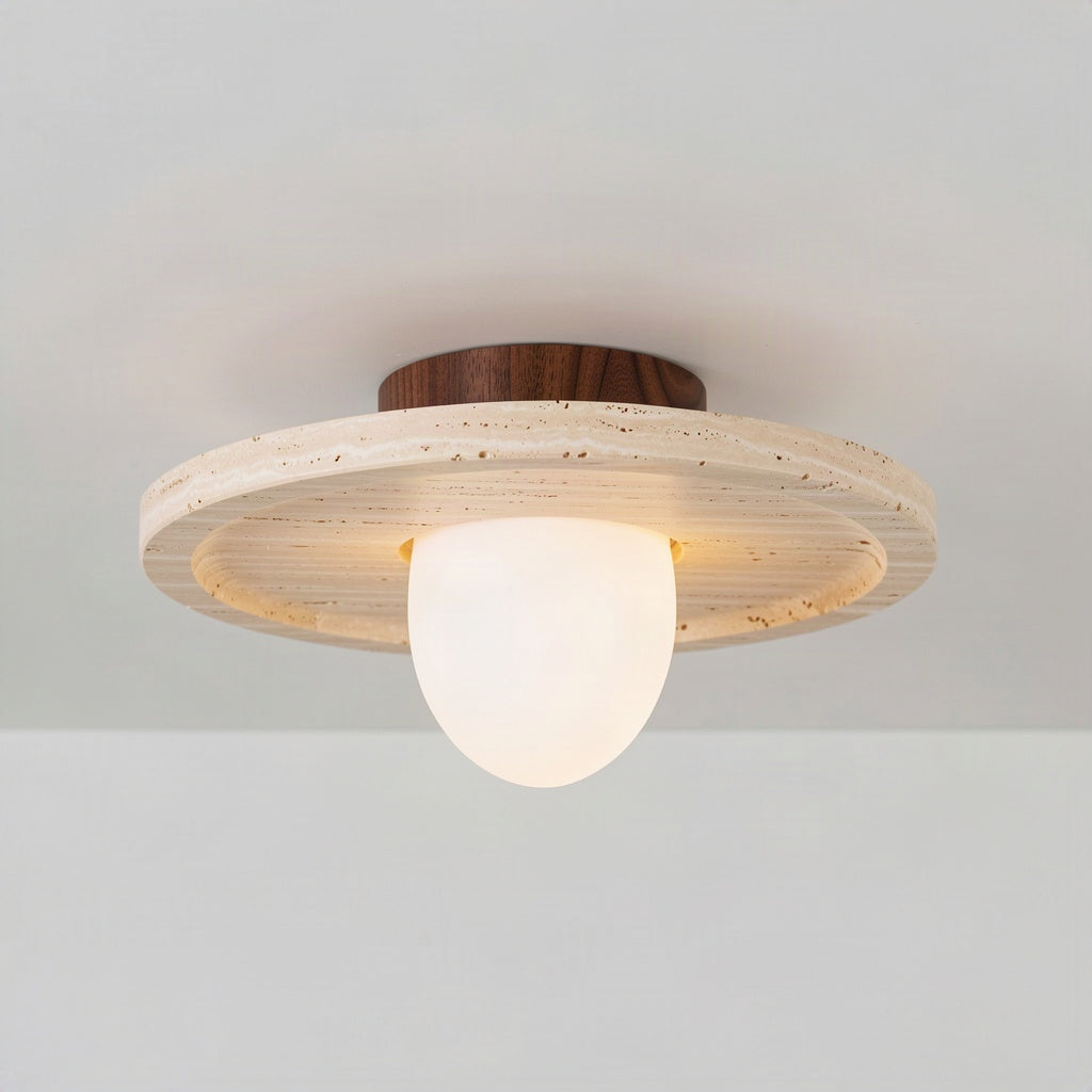 Angled view showing the shallow depth of the travertine disc and the opal diffuser below