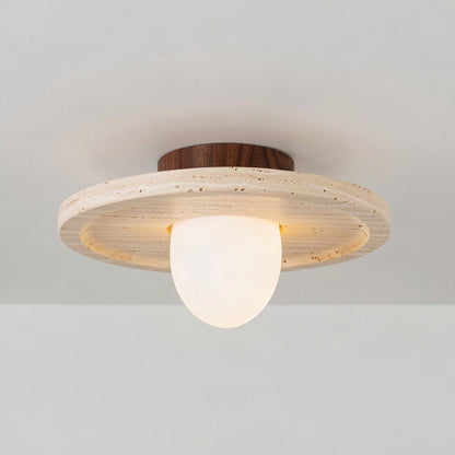 Angled view showing the shallow depth of the travertine disc and the opal diffuser below