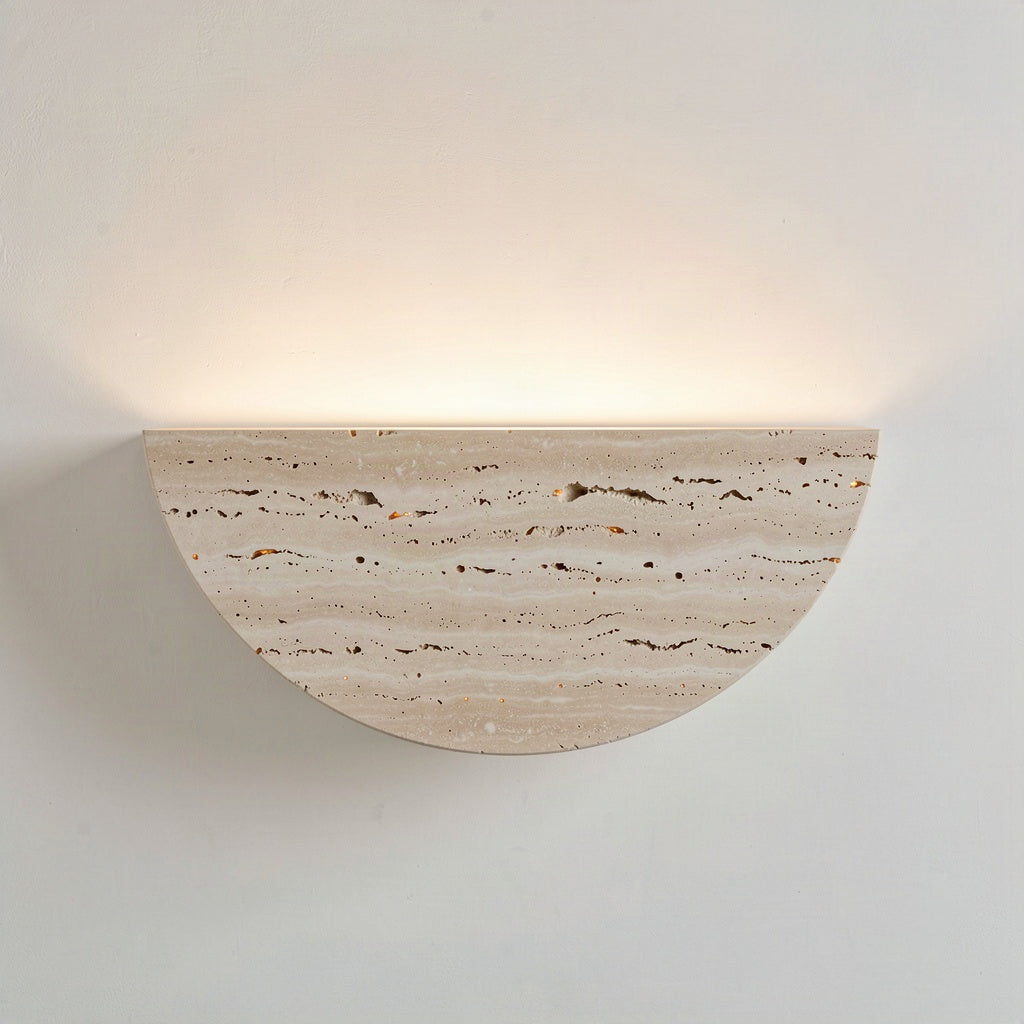 Travertine half-moon wall light washing warm light up a pale wall