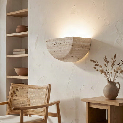 The half-moon sconce mounted beside shelving in a warmly lit living space