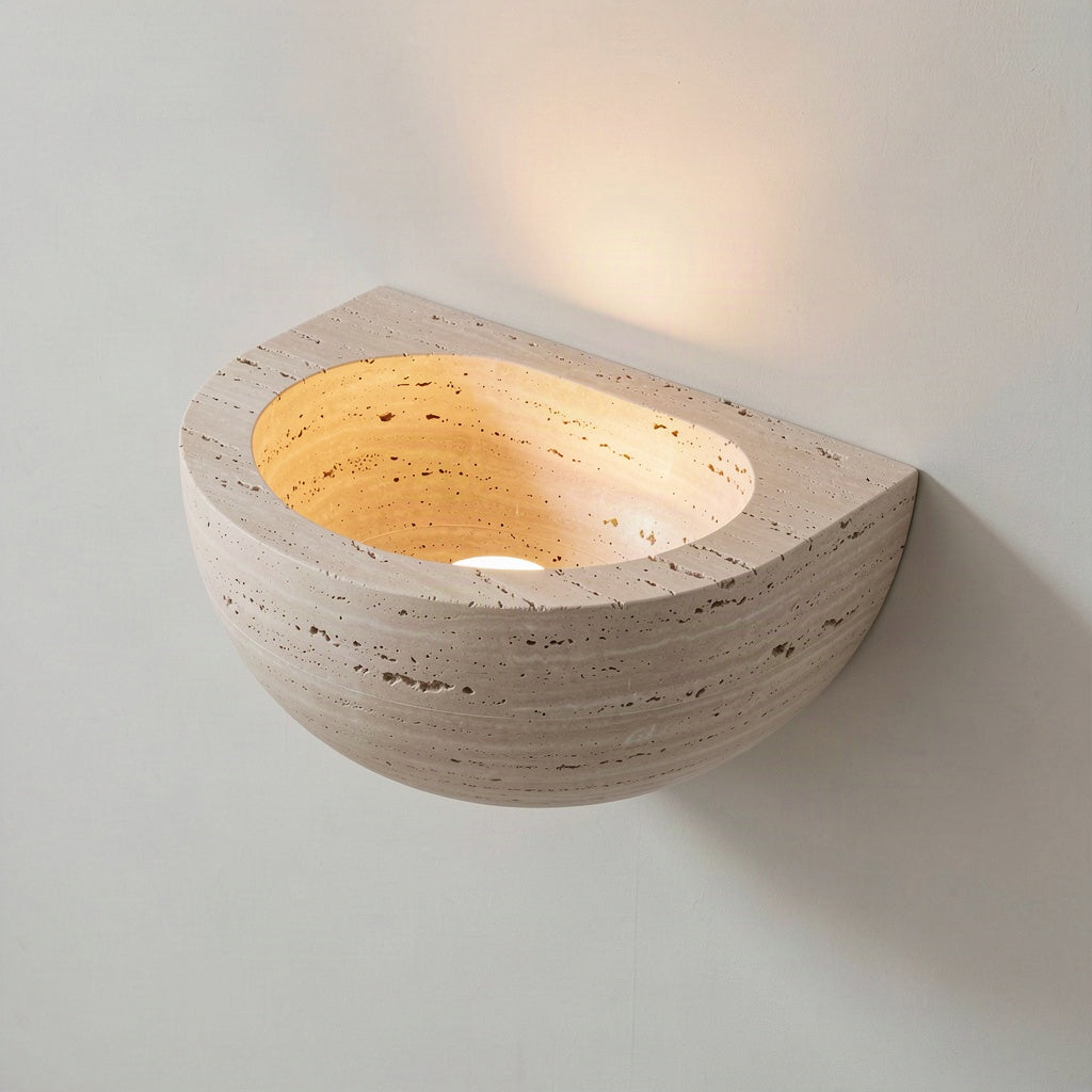 Angled view showing the hollow bowl and open top edge of the travertine sconce