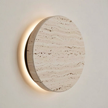 Angled view showing the thickness of the travertine disc and the light escaping behind it