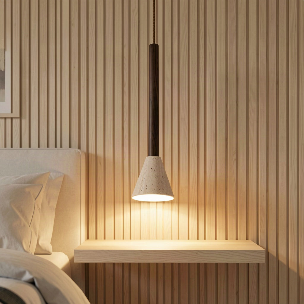 The trumpet pendant lit above a floating timber bedside shelf against a slatted wood wall