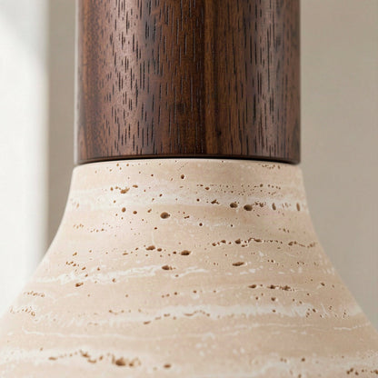 Close-up of the join between the walnut stem and the open-pored travertine shade